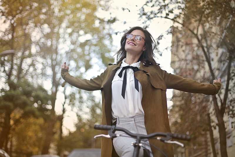 Woman on bicycle wearing vintage