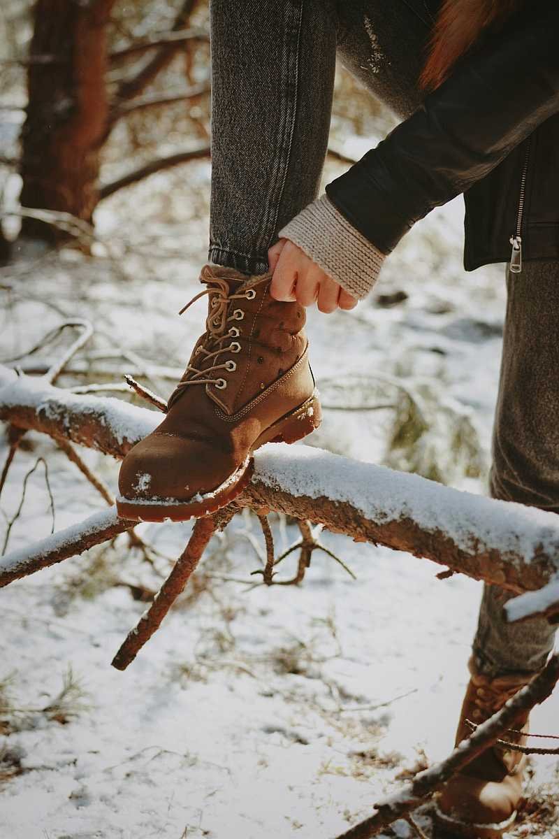 Woman wearing boots on snow