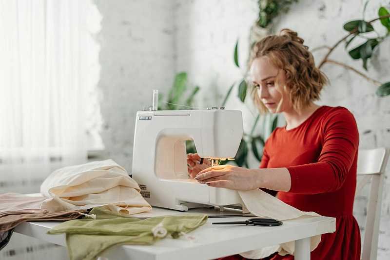 Woman working with old clothes